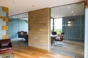 02, Frameless glass partitioning fitted to a stone wall