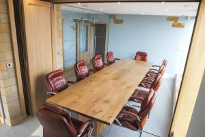 08, Solid oak boardroom table extended to seat ten